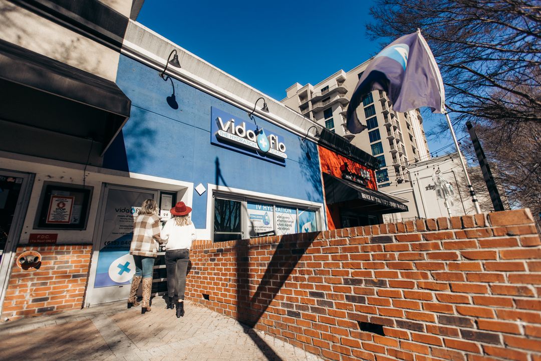 Two people walking into a Vida-Flo location in Buckhead, GA.