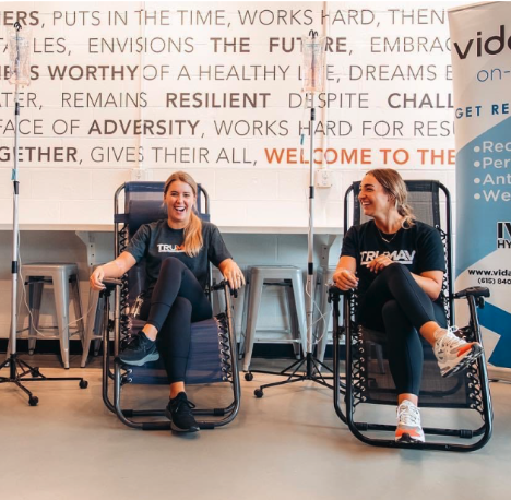 Two people enjoying mobile IV Hydration Therapy in Buckhead, GA - a service offered by the Vida-Flo team.