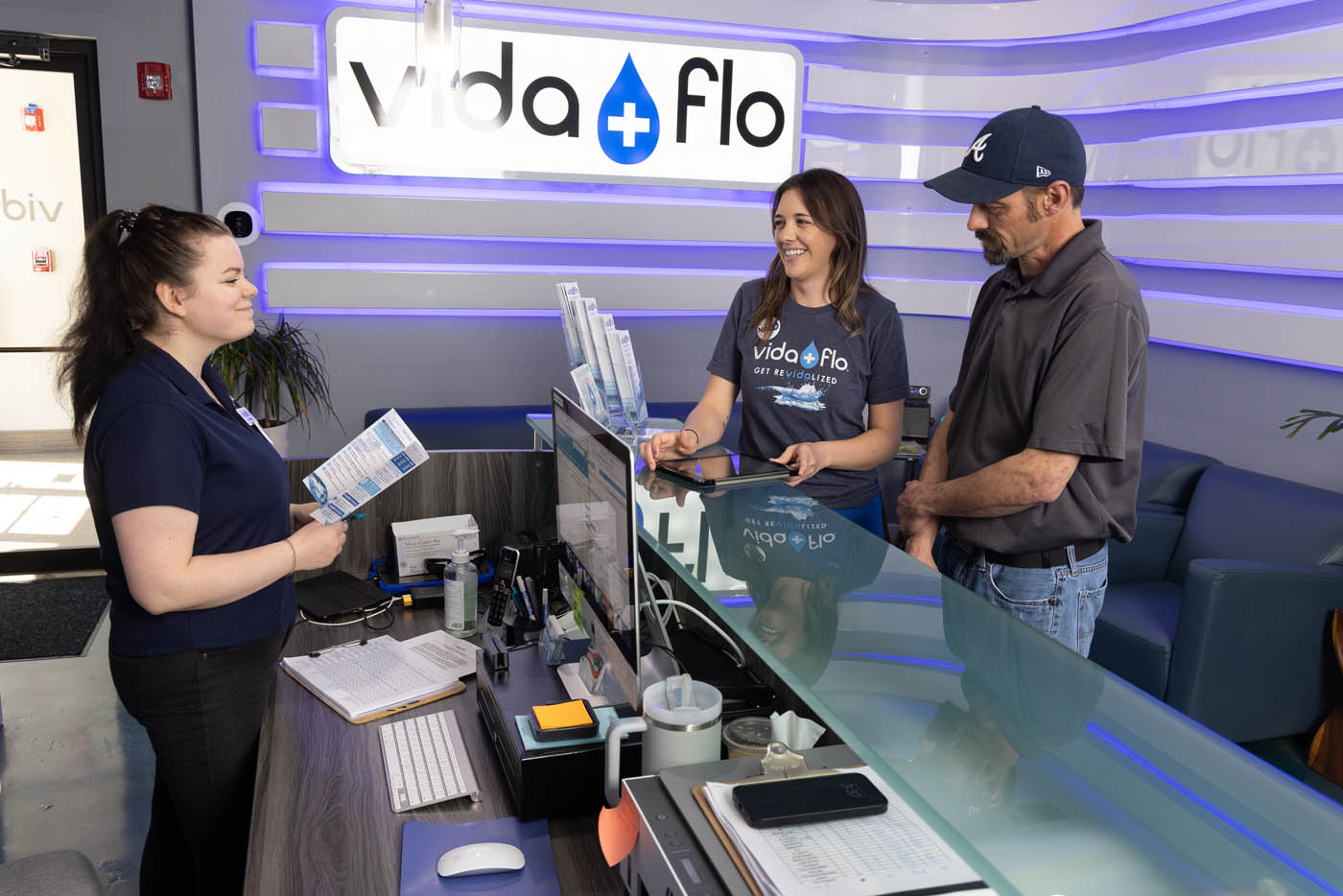 Two clients talking with our caring staff about our IV treatment in Buckhead, GA.