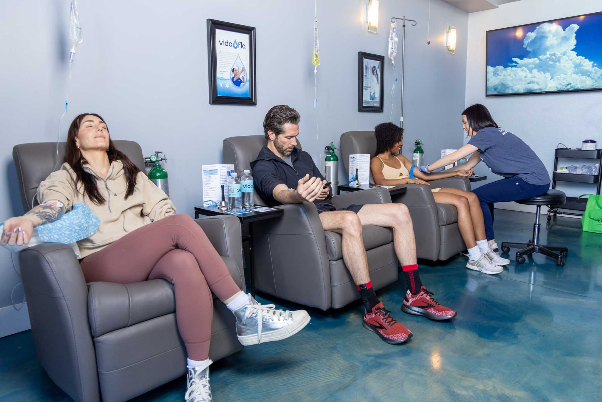 A row of friends enjoying the Vida-Flo experience while receiving an iv vitamin treatment in Buckhead, GA.